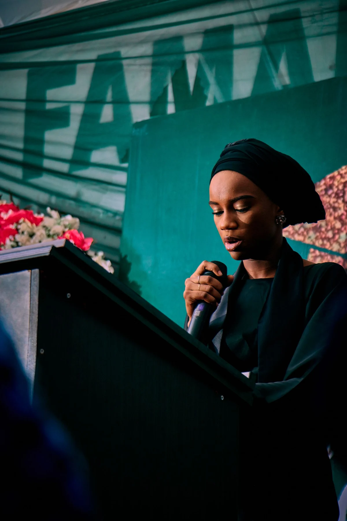 A woman speaking at a podium; illustrative stock photography